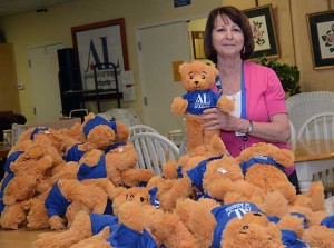 Volunteer Marty Hlad helps prepare the Assistance League of Atlanta teddy bears. (photo by Leita Cowart)